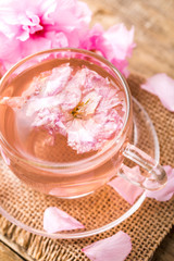 Fototapeta na wymiar Cherry blossom herb tea on table. sakura
