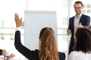 Training participant raise hand ask question at employees team workshop