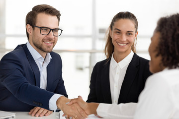 Happy hr handshaking hiring successful job candidate at business interview