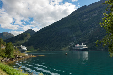 Fototapeta na wymiar Two Cruise Ships with Engines turned on, in the famous Geiranger Fjord in Norway