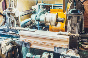 Cutting the lock and joints in the profiled bar to assemble a wooden house - sawmill - production of glued laminated timber