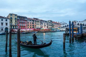 Obraz na płótnie Canvas VENICE, ITALY- December 21, 2017 : Tourists on water street with Gondola in Venice,ITALY