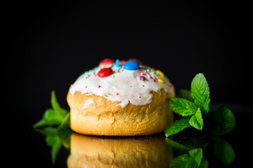 homemade sweet cake in the glaze on a black