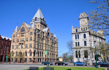 Syracuse savings Bank Building (left) and Gridley Building (right) at Clinton Square in downtown Syracuse, New York State, USA. Syracuse Savings Bank Building was built in 1876 with Gothic style. - obrazy, fototapety, plakaty