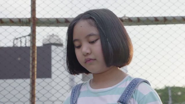 Slow motion portrait of Lovely Asian girl alone in school
