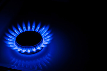 Blue flame of a gas stove in the dark. gas-burner