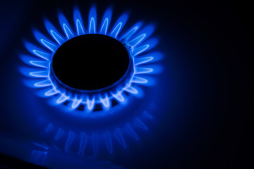 Blue flame of a gas stove in the dark. gas-burner
