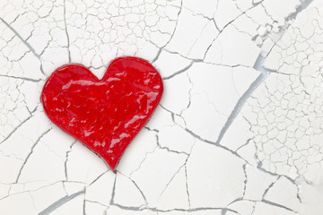 Red love heart on cracked background with copy space