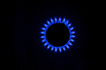 Blue flame of a gas stove in the dark. gas-burner