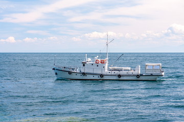 Fishing ship on the water surface in clear weather