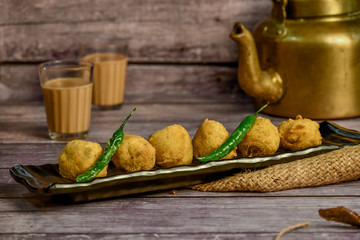 Potato Wada, Batata Vada a popular vegetarian fast food in Maharashtra,It literally means potato fritters. It consists of a potato mash patty coated with chick pea flour, then deep-fried.