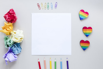 Rainbow hearts with paper and pencils