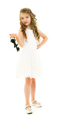 Little girl is holding keys to the door.