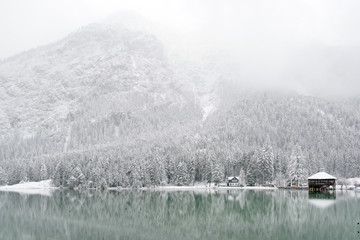 Snow falling over Dobiacco lake in Italy, Europe
