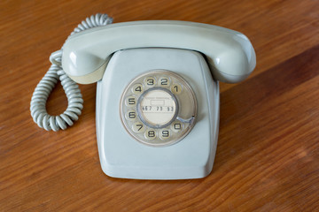 Old grey telephone with rotary dial