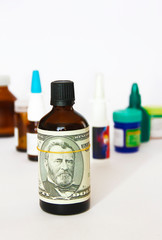 dollar on a bottle of medicine on the background of medical drugs