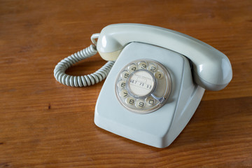 Old grey telephone with rotary dial