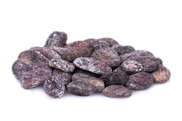 A heap of  rotten, moldy cocoa beans isolated on white. Shallow depth of field. Macro shot.