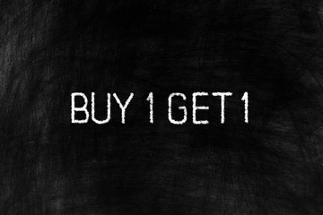 Buy One Get One on Black Chalkboard Background, Suitable for Business Concept.