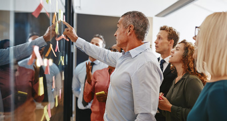 Diverse businesspeople brainstorming together with sticky notes - Powered by Adobe