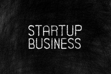 Obraz premium Startup Business on Grunge Chalkboard Background.