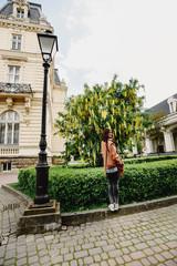 Fototapeta premium stylish gorgeous hipster girl traveling in europe city in sunny spring time