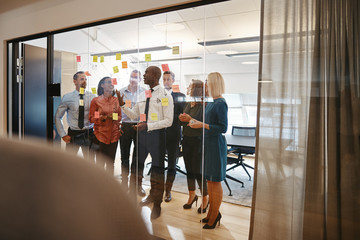 Diverse business team brainstorming with sticky notes in an offi