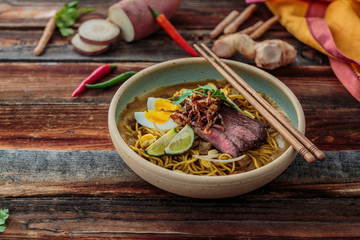 Malaysia Spicy Noodle Mee Rebus With Beef Egg and fried onion, copy space