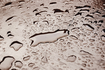 raindrops on wooden table in the street in europe city, wallpaper texture