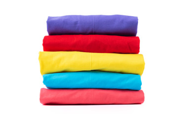Stack of Colorful cotton T shirt isolated on white background.