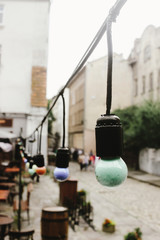 retro beautiful lamp lights on garland at cafe terrace in the street in europe city holiday, space for text