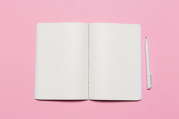 school notebook on a pink background, notepad on a table