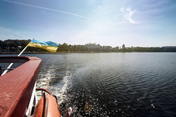 sailing on  boat at sunny lake at the city, summer vacation concept