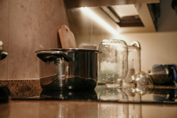 Naklejka na ściany i meble Pot stands on marble surface in kitchen