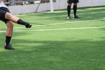 Obraz premium Feet of football player on green field