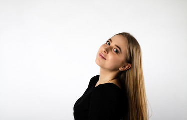 Fototapeta premium Young woman in black on bright background.