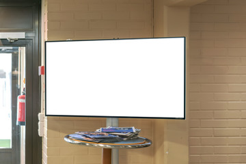 empty information board on a table with information for visitors near the exit from the hotel,...