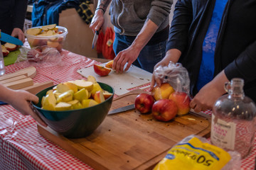 people cutting up apples