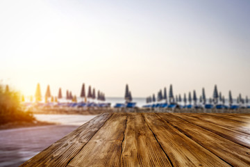Table background of free space for your decoration and morning blurred background of beach and sea 