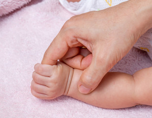 Hand of baby touch finger mother.