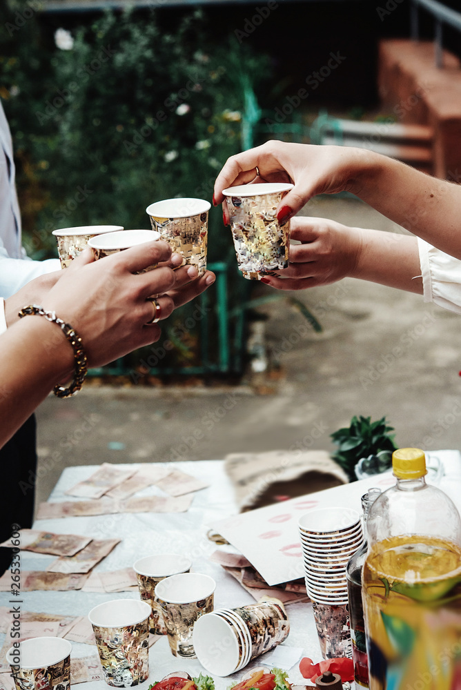 Wall mural hands of people with cups of alcohol, celebrating and toasting, wedding or birthday event