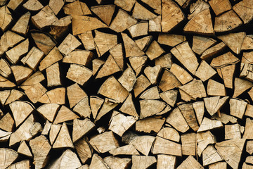natural stocked firewood in a pile, wooden abstract background, energy enviroment concept
