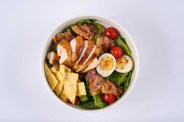 Homemade salat with chiken, eggs, cherry and bacon