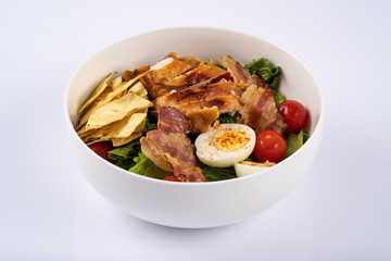 Homemade salat with chiken, eggs, cherry and bacon