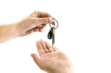 hand gives keys to hand on white background