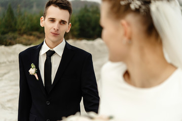 happy bride and stylish groom posing and smiling, luxury elegant wedding