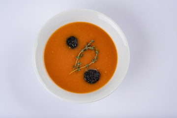 Bowl of squash soup in a white plate