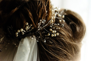 gorgeous elegant bride hair style with wreath of stones and pearls in luxury vintage room