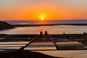 Naklejka na ściany i meble Sunset at Salinas de Janubio. Old salt pans in the south of Lanzarote were they harvest salt the traditional way