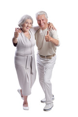 Portrait of happy senior couple showing thumbs up